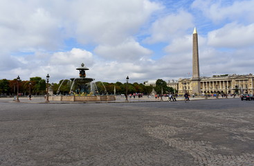 Fototapeta na wymiar Paris, France, August 2018. La Concorde Square. Fountain, obelisk, street lights and tourists. Cloudy sky.