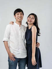 Asian couple hugging together with white background.