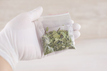 expert analysis of the contents of the package with physical evidence, a suspicion of the presence of narcotic drugs: a packet of dry vegetable content in the hands of a medic