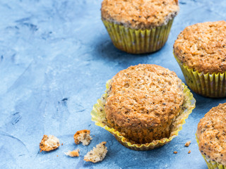 Muffins with chia seeds. Homemade muffin on blue concrete textured background