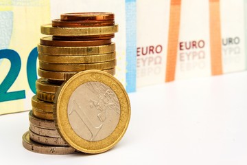 Euro coins and banknotes on a white background. Exchange rate. Stock market trading. The common European currency.