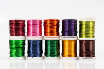 Some  spools of colored metallic thread