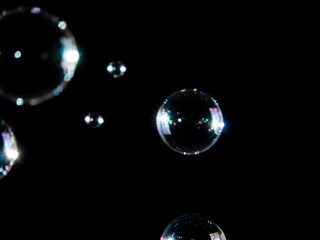 Blurred soap bubbles on black background, Photo of soap bubble,