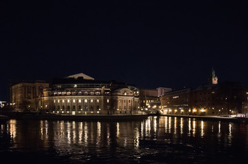 Fototapeta na wymiar Evening view in Stockholm shilouettes of old town, parliament houses , bridges and lake Mälaren 