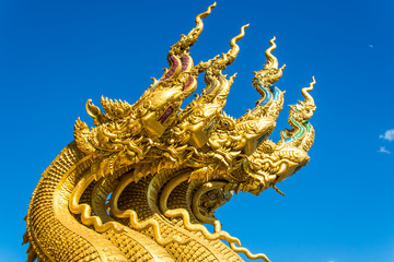 Fototapeta na wymiar Golden Naga Statue with background sky