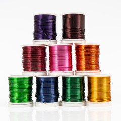 Some  spools of colored metallic thread