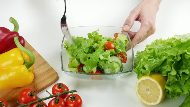 Healthy food. Vegetarian food. Young man coocking vegetable salad observing diet and counting calories wellness. Top view