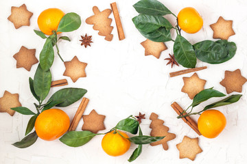 Border of Christmas star cookies with spices and mandarin on white background with copyspace.