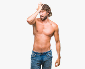 Fototapeta premium Handsome hispanic model man sexy and shirtless over isolated background surprised with hand on head for mistake, remember error. Forgot, bad memory concept.
