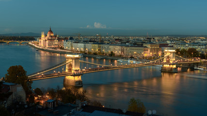 Fototapeta na wymiar Panorama of the Hungarian Parliament, and the Chain bridge (Szechenyi Lanchid), over the River Danube, Budapest, Hungary, at night