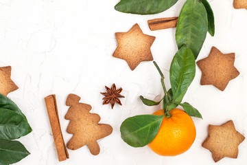 Border of Christmas star cookies with spices and mandarin on white background with copyspace.