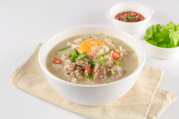 Congee with minced pork and boiled egg in bowl