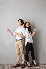 Fototapeta premium Full length of cheerful asian couple standing