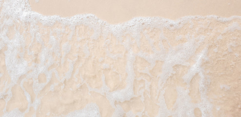 white ocean wave on sandy beach in summer vacation copy space for your text