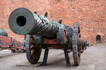 Old brass canon on wooden wheels