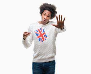 Afro american man flag of United Kingdom over isolated background with open hand doing stop sign with serious and confident expression, defense gesture