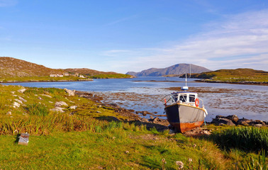 Scottish landscapes: an old boat on a lake shore at Isle of Harris, Outer Hebrides, UK.