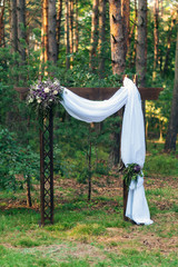 Wedding arch decorated with flowers outdoors. Beautiful wedding set up. Modern wedding in the summer