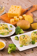 Potato gratins with broccoli florets.
