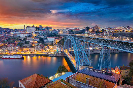 Porto, Portugal. Cityscape image of Porto, Portugal with the famous Luis I Bridge and the Douro River during dramatic sunset.
