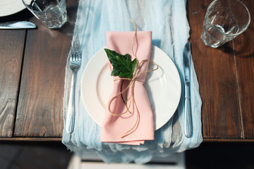 Elegant wedding table arrangement, floral decoration, restaurant. Wedding table setup. Wedding in the forest. Banquet