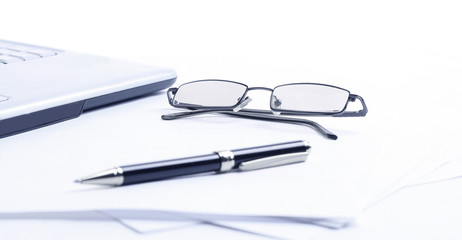 closeup. notebook ,glasses and pen on the workplace of the busin