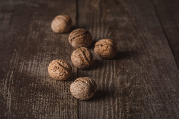 close up view of tasty walnuts on wooden surface