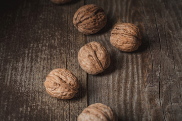 close up view of tasty walnuts on wooden surface