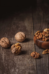 close up view of walnuts in bowl on wooden surface