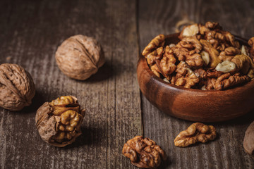 close up view of walnuts in bowl on wooden surface