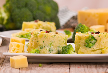 Potato gratins with broccoli florets.