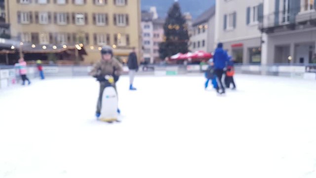 children play ice skating on a skating rink - blurred 4k footage
