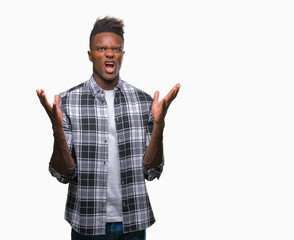 Fototapeta premium Young african american man over isolated background crazy and mad shouting and yelling with aggressive expression and arms raised. Frustration concept.