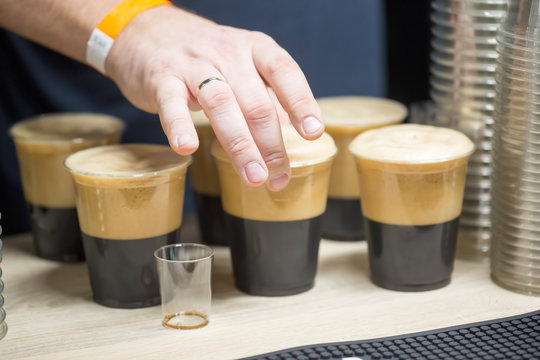 Man serving black stout on beer fest 