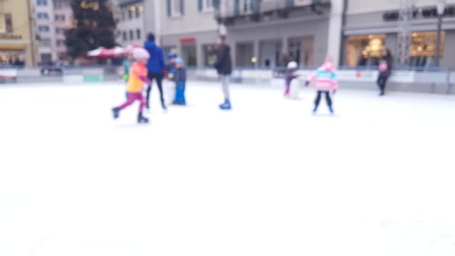 children play on an ice rink - blurred footage