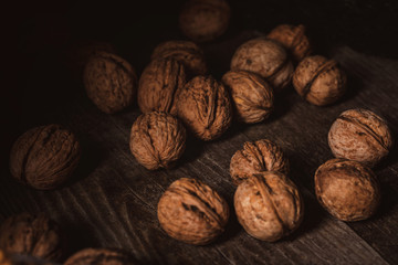 close up view of walnuts in husk on wooden table