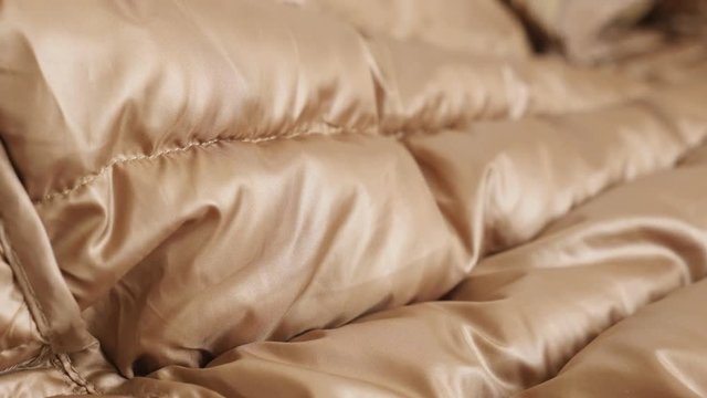 Tilting over modern quilted jacket fabric 4K footage