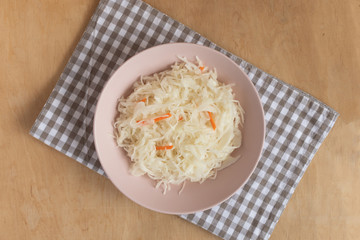 Pickled cabbage in a bowl on table top view. Fermented vegetables. 
