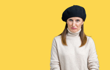 Middle age mature woman wearing winter sweater and beret over isolated background depressed and worry for distress, crying angry and afraid. Sad expression.