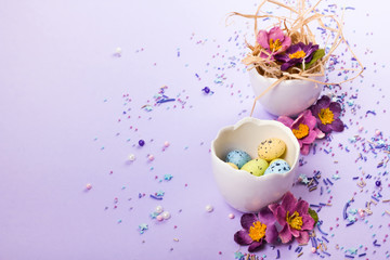 Easter decor in pastel colors. Easter eggs, candy, sweets, flowers and eggshells.