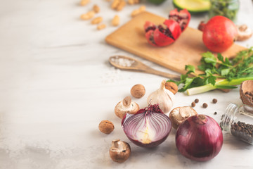 Cuisine, background of vegan food, avocado, pomegranate, green beans mushrooms, broccoli mushrooms, onions, nuts, greens. Clean and healthy food, detox, sports and diet on a white background