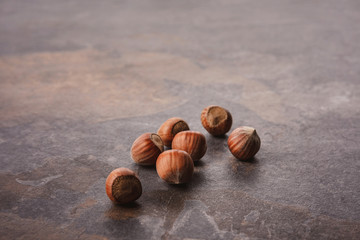 close up view of shelled hazelnuts on grey tabletop