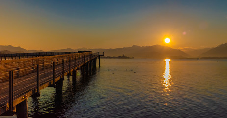 Fototapeta na wymiar Stunning sunset on the shores of the Upper Zurich Lake near Rapperswil, Switzerland