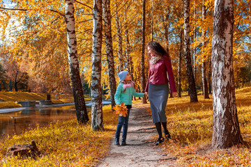 Fototapeta premium Mother and daughter against the background of autumn. Autumn happiness. A resident of the Caucasus, Europe.