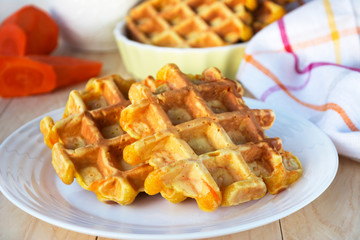 Carrot honey waffles on white plate. 