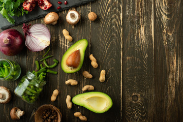 Vegan food, detox, avocado, fruit, green beans, broccoli, nuts and mushrooms. Diet and healthy food, vitamins and sports. Flat-lay, Clean and healthy food on a wooden background.