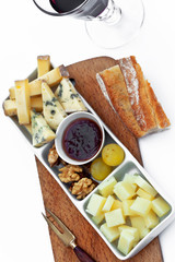 Plate of cheese and fruits on a table
