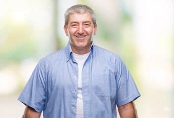 Handsome senior man over isolated background with a happy and cool smile on face. Lucky person.