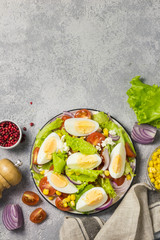 Egg tomato corn salad with mustard olive oil dressing. Top view, space for text.