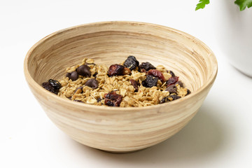 Bowl of granola cereal with raisins, cherries, nuts, and chocolate chips